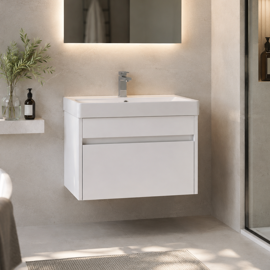 A modern white wall-mounted bathroom vanity with an integrated rectangular sink and a chrome faucet, shown in a clean, contemporary bathroom setting with a mirror, shelf, and glass shower door.