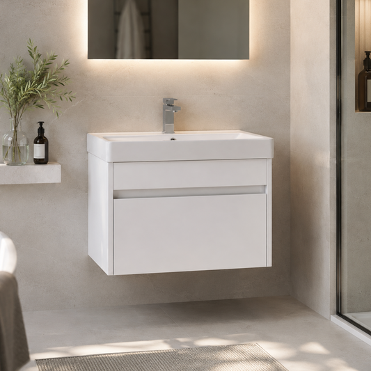 A modern white wall-mounted bathroom vanity with an integrated rectangular sink and a chrome faucet, shown in a clean, contemporary bathroom setting with a mirror, shelf, and glass shower door.