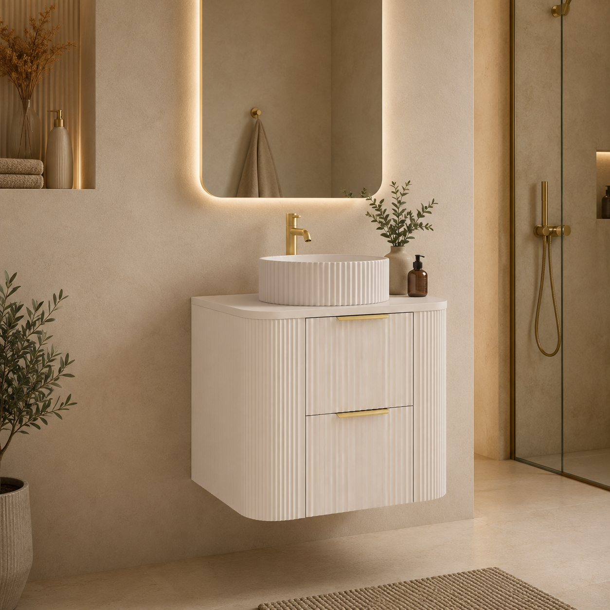 A modern floating bathroom vanity with a ribbed white cabinet, a matching round vessel sink, and a gold faucet, set in a warm beige bathroom with a backlit mirror and glass shower door.
