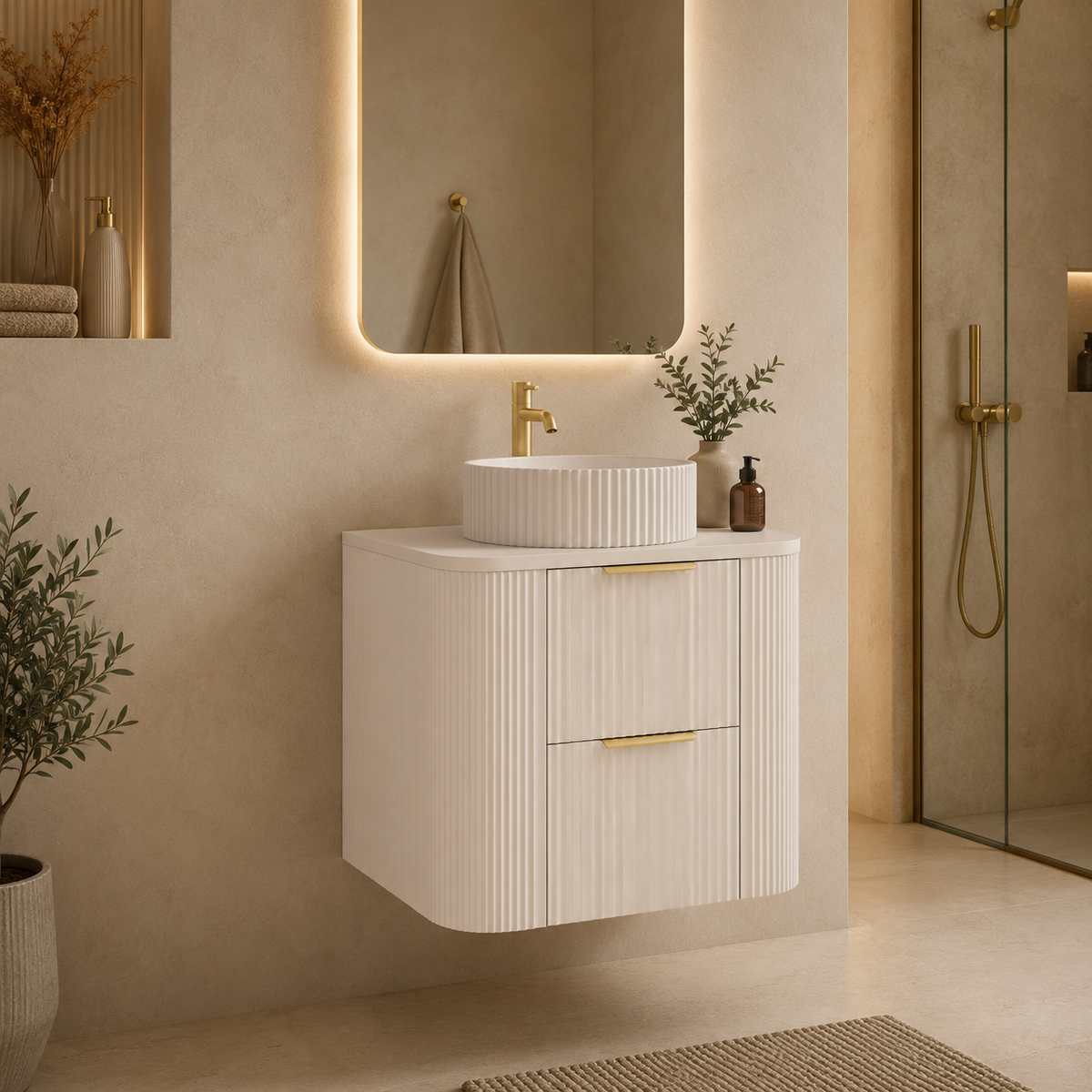 A modern floating bathroom vanity with a ribbed white cabinet, a matching round vessel sink, and a gold faucet, set in a warm beige bathroom with a backlit mirror and glass shower door.